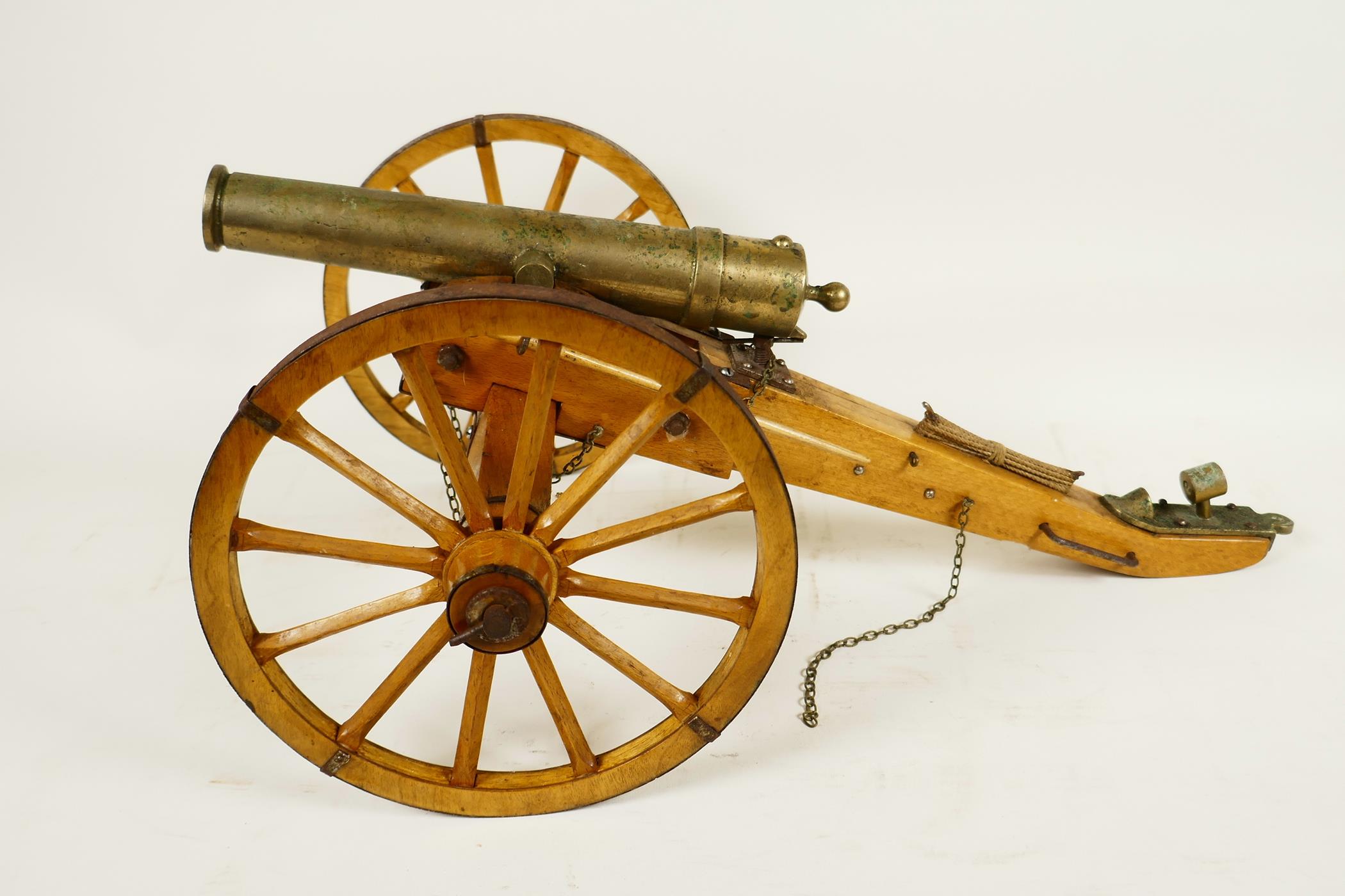 An antique ornamental table top bronze cannon, on a hand made wooden carriage with metal fittings,