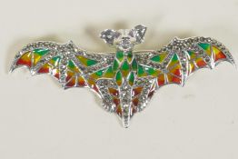 A silver and plique a jour brooch in the form of a bat, 3" wide