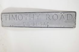 An aluminium street sign with raised enamelled letters, 44" x 9"