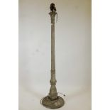 A metal and plaster standard lamp painted over what appears to be a copper and brass metal sheath,