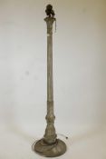 A metal and plaster standard lamp painted over what appears to be a copper and brass metal sheath,