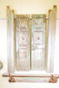 Architectural salvage: A pair of Indian teak storm doors, with frame, each door with four moulded