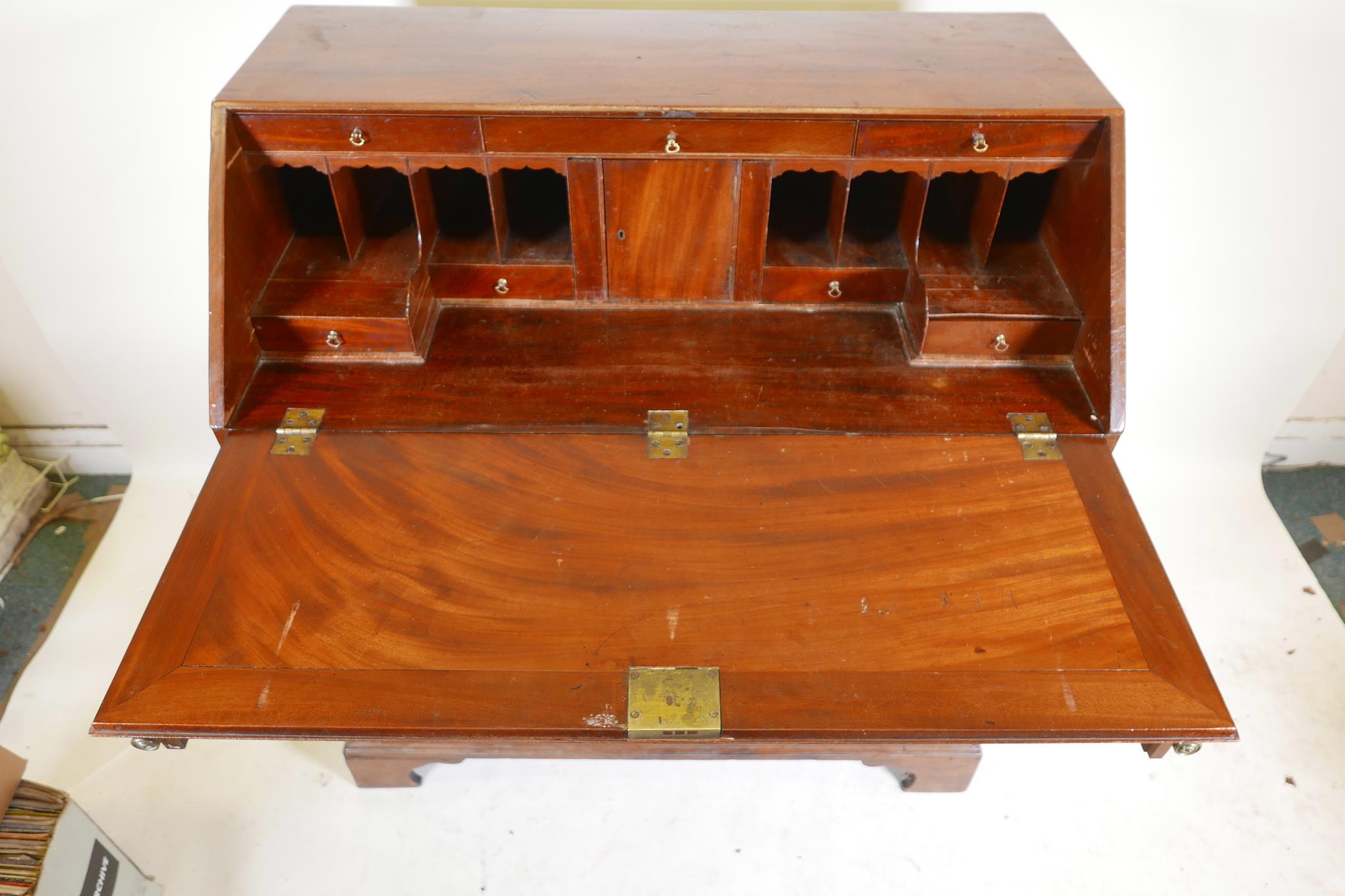 A Georgian mahogany fall front bureau, the fitted interior with secret drawer and slides over four - Image 4 of 5