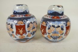 A pair of pottery lamp bases in the form of lidded ginger jars decorated in the Imari palette, 8¼"