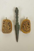 A miniature Tibetan metal phurba with mask and vajra decoration to handle, together with two Tibetan