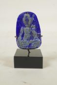 A Chinese carved lapis lazuli pendant decorated with Buddha, in a display mount