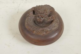 A Japanese wood trinket box, the cover carved as a dragon, 2¾" diameter