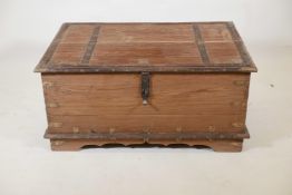 An Indian teak and brass mounted chest with decorative studs and half hinged fold over top, raised