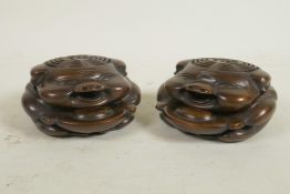 A pair of Chinese bronze incense burners in the form of pigs, with pieced lids decorated with