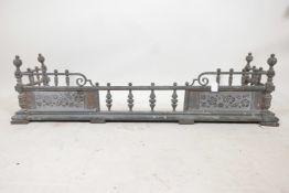 A Victorian metal fire fender, with gilt repousse panels and decoration in the Aesthetic style,