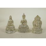 Three Chinese white metal cast figures of Buddha and Quan Yin, largest 3½" high