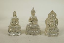 Three Chinese white metal cast figures of Buddha and Quan Yin, largest 3½" high