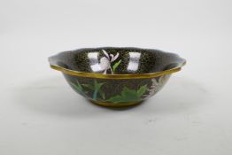 A Chinese black ground cloisonne bowl with frilled rim and chrysanthemum decoration, 8½" diameter