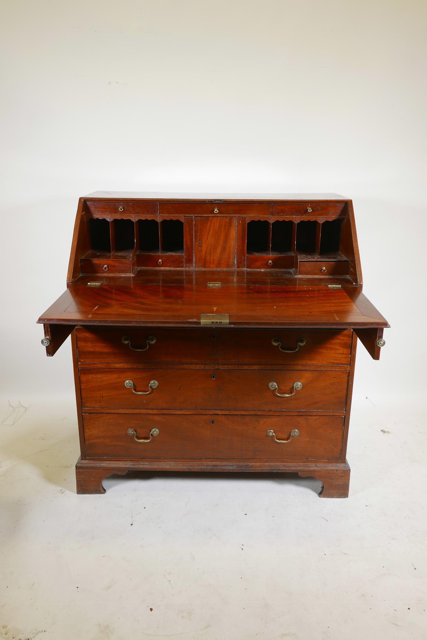 A Georgian mahogany fall front bureau, the fitted interior with secret drawer and slides over four - Image 3 of 5