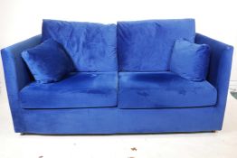 A Made 'Milner' two seater sofa bed in blue velvet