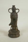 A Chinese bronze of Quan Yin standing on a lotus throne, with a distressed gilt patina, impressed