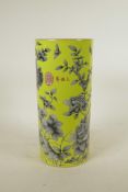 A Chinese yellow ground porcelain cylinder vase with black and white floral decoration, red