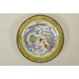 A Chinese Canton enamelled copper shallow saucer, decorated with a dragon and phoenix, 5"