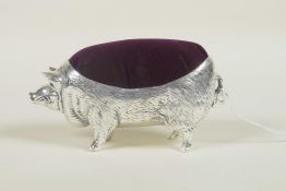 A silver plated pincushion in the form of a pig, stamped 800, 4" long
