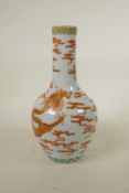 A Chinese polychrome porcelain bottle vase, decorated with an iron red dragon chasing the flaming