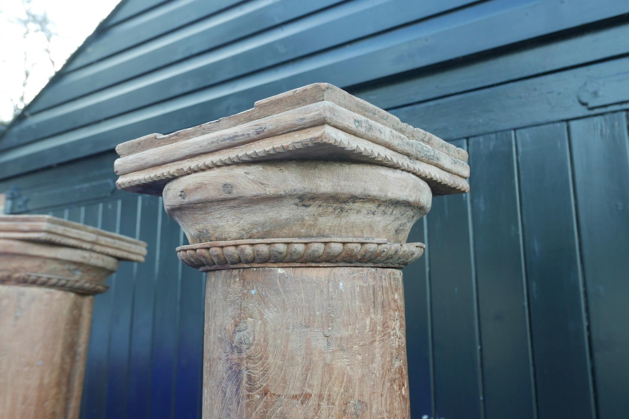 Architectural salvage: A pair of Indian teak columns with carved capitals, mounted on carved stone - Image 3 of 4
