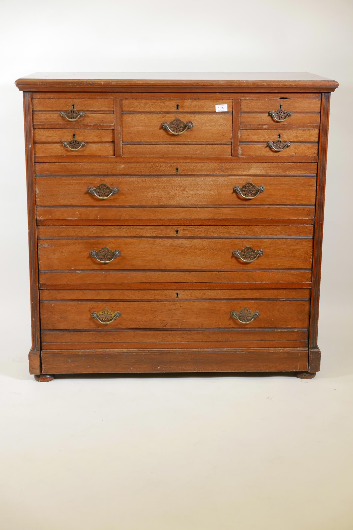 A 1920s walnut chest of drawers, five small over three long drawers, with reeded decoration, 41" x