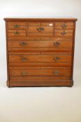 A 1920s walnut chest of drawers, five small over three long drawers, with reeded decoration, 41" x