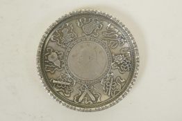 A Chinese white metal coin dish decorated with the emblems of the Eight Immortals, 3½" diameter