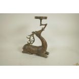 An archaic style Chinese bronze figure of a deer supporting a candle/bowl stand, 13" high
