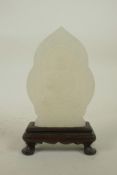 A Chinese white hardstone ornament in a hardwood stand with carved Buddha decoration, 6½" high