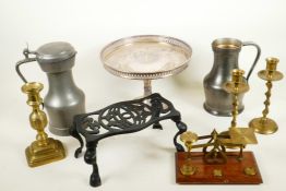 A box of metalwares including cast iron footman, pewter tankards, brass scales etc