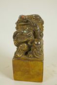 A Chinese gilt bronze seal, the top formed as mythical beasts set with coloured stones, on square 5"