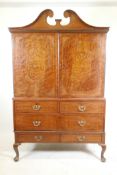 A C19th plum pudding mahogany press cupboard, with inlaid seaweed panel panels, the upper section