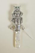 A sterling silver novelty baby's rattle in the form of an anthropomorphic cat, with mother of