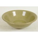 A Chinese celadon glazed porcelain bowl with central floral decoration, 7" diameter