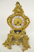 An ormolu Rococo style mantel clock, the movement striking on a gong, with gilded dial and inset