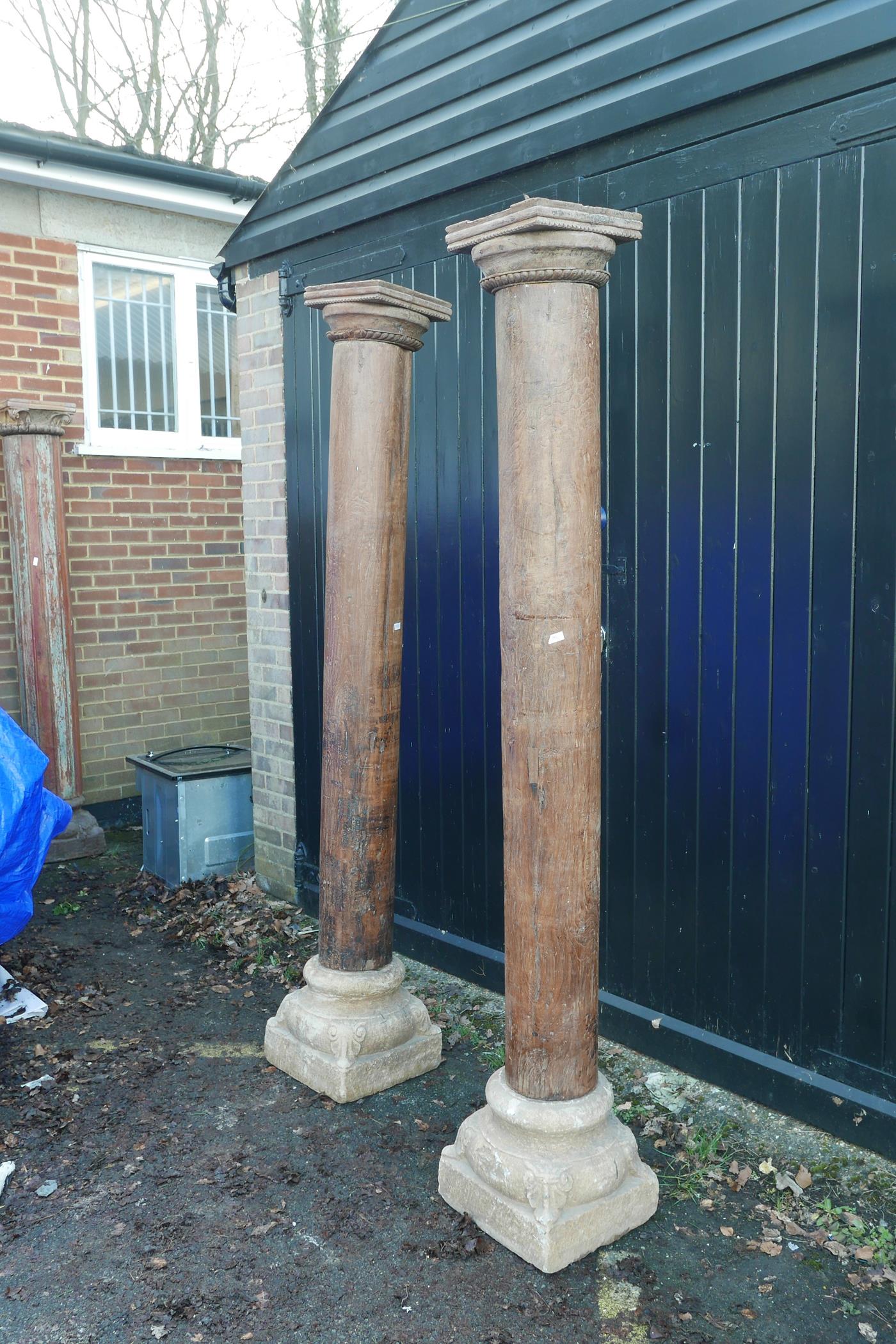 Architectural salvage: A pair of Indian teak columns with carved capitals, mounted on carved stone - Image 2 of 4