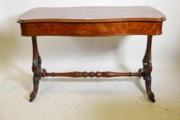A good Victorian walnut two drawer stretcher table, with serpentine top, raised on carved and