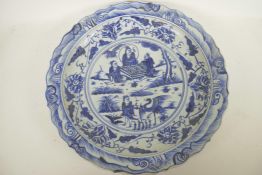 A Chinese blue and white porcelain charger decorated with figures in a garden, 18½" diameter