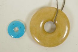 A Chinese turquoise pi-disc pendant, and another larger composition pi disc, largest 2½" diameter