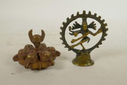 An Indian brass tika box with skull decoration, together with a bronzed metal figure of a many armed