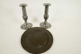 A pair of pewter Queen Anne style candlesticks, 6½" high, and an antique pewter plate, 7¾" diameter