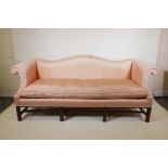A pair of American vintage camel back settees with pink silk upholstery on fluted square supports,