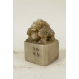 A Chinese soapstone seal with carved dragon knop and character inscription to side, 2" x 2", 3" high