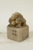 A Chinese soapstone seal with carved dragon knop and character inscription to side, 2" x 2", 3" high