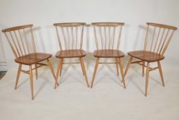 Four blonde Ercol stick back dining chairs