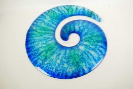 A mottled blue studio glass wall hanging in the form of a shell, 17" diameter