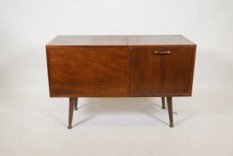 A 1970s rosewood cased music centre with built in Garrard model 4HF (H) record player, with fall