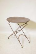 A French wrought metal folding cafe table, 23½" diameter