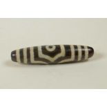 A Tibetan agate Dzi bead, 2" long